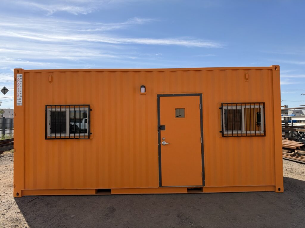 20 foot container office, front view with door and two barred windows
