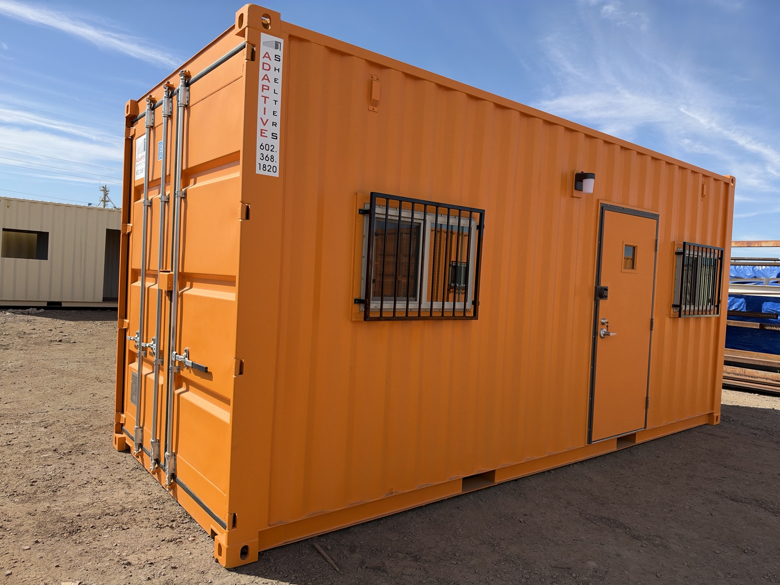 20 foot container office exterior with barred windows and steel man door, Adaptive Shelters Arizona