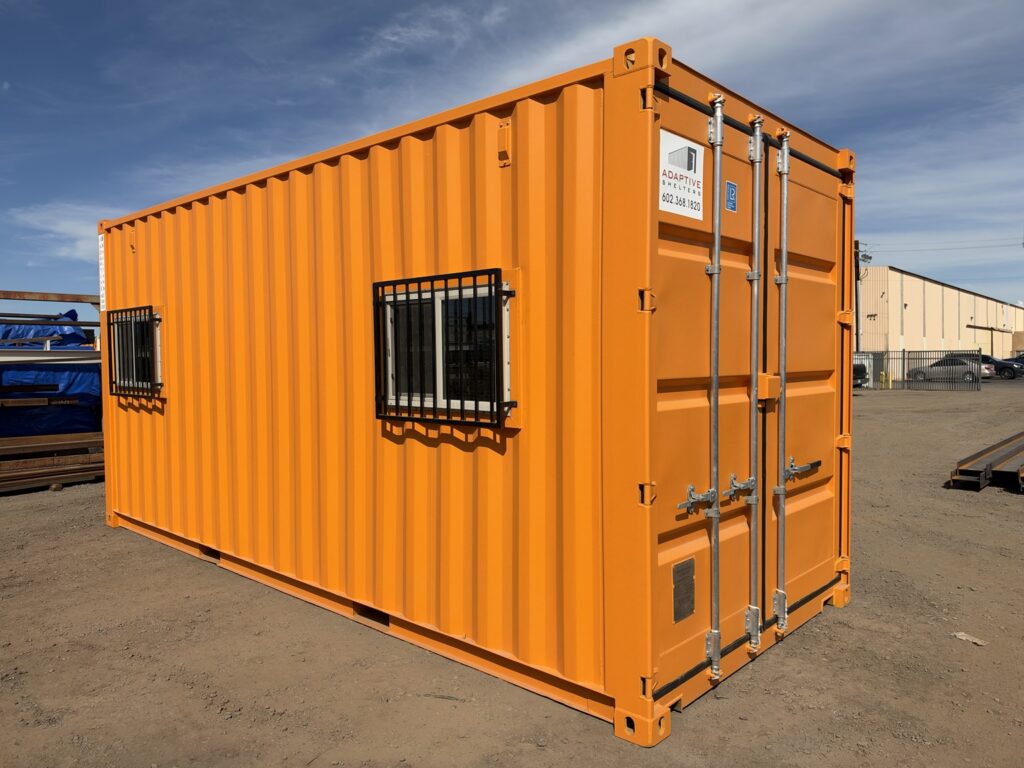 20 foot container office, back corner view with cargo doors and barred windows