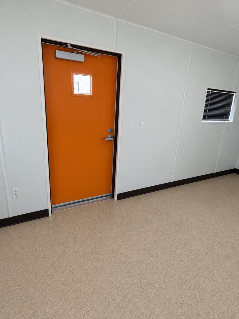 Inside a 20 foot container office, access door and window