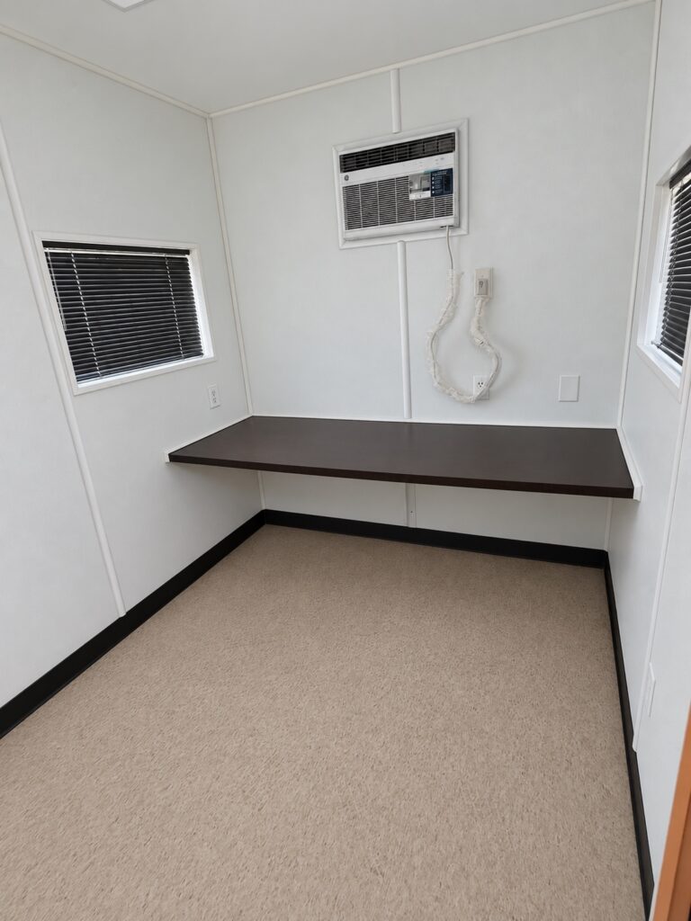 Office side of a 40 foot office and storage combo with countertop desk and wall air conditioner